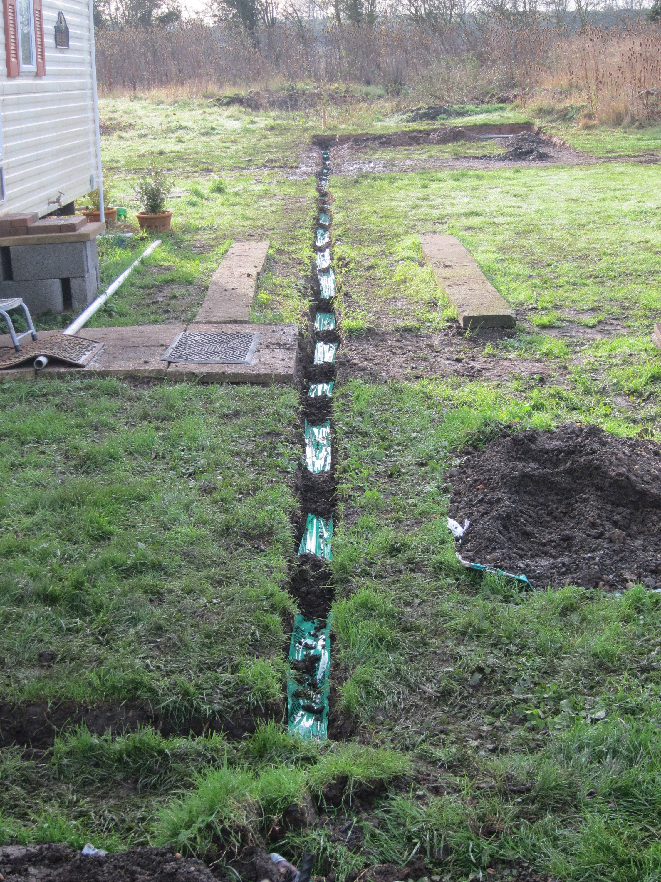 Part-backfilled trench with new telephone cable