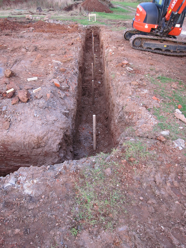Depth marker pegs in house foundation trench
