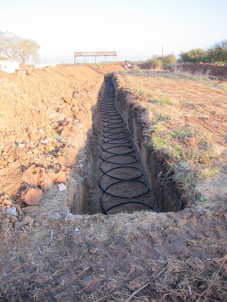 Northern GSHP trench with slinky collector pipe installed