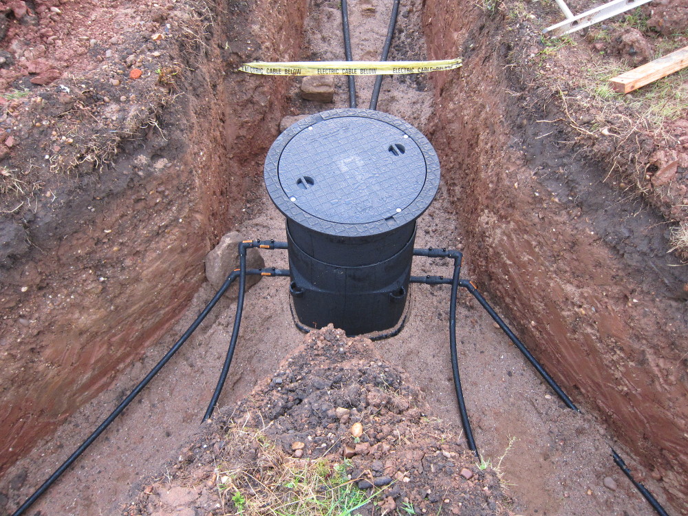 GSHP collector pipes connecting at manhole
