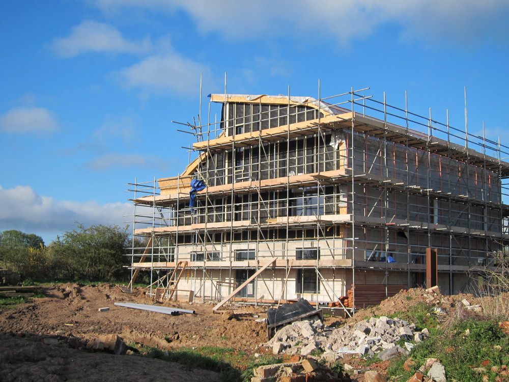 Black membrane and vertical battens on east wall