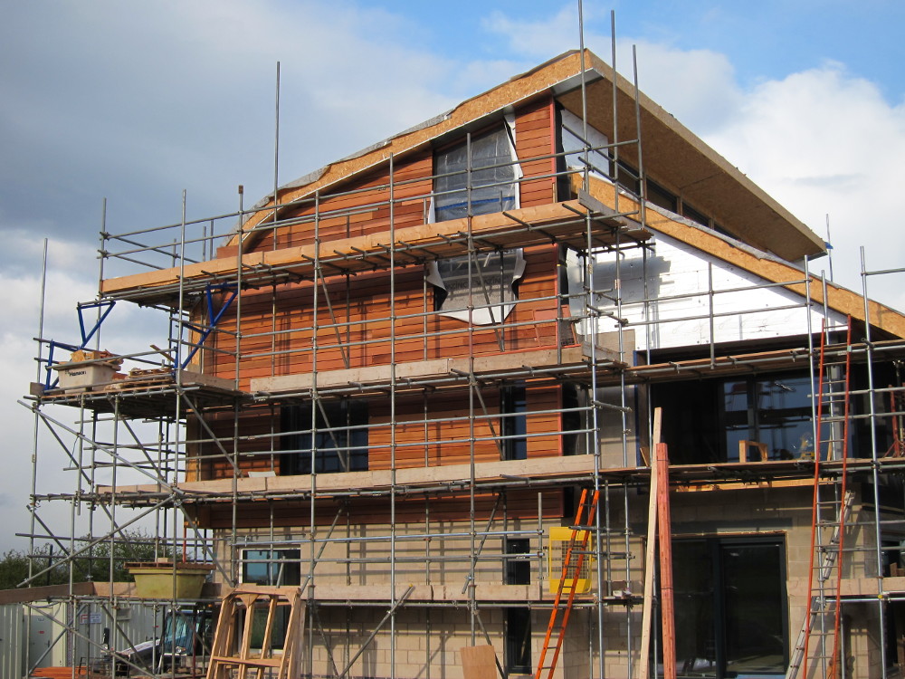 Cedar cladding up to main roof on west elevation
