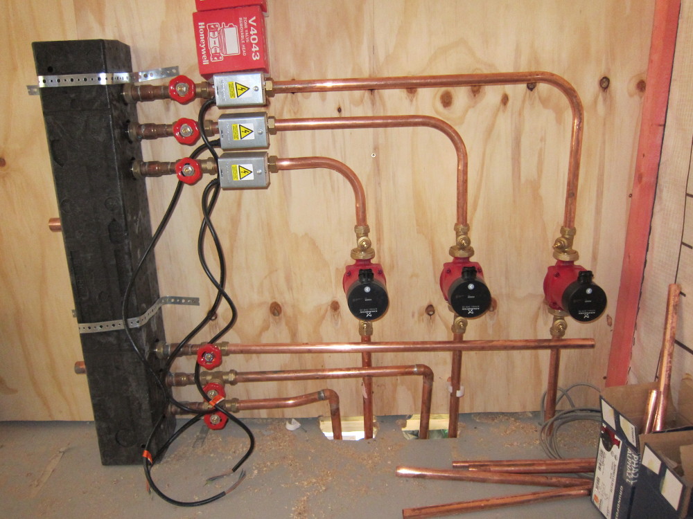 FIrst-fix of the low-loss header feeding the three heating circuits via Honeywell zone valves and Grundfos Alpha2 pumps