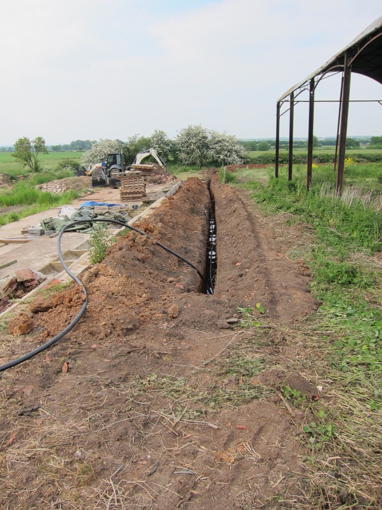 Cable trench alongside outbuildings