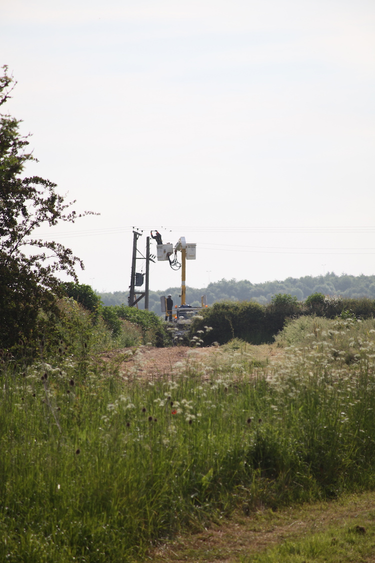 Live working on the 11,000 volt line installing new connection points for the transformer
