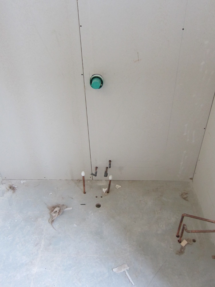 Plasterboard over the bath pipework on the second floor