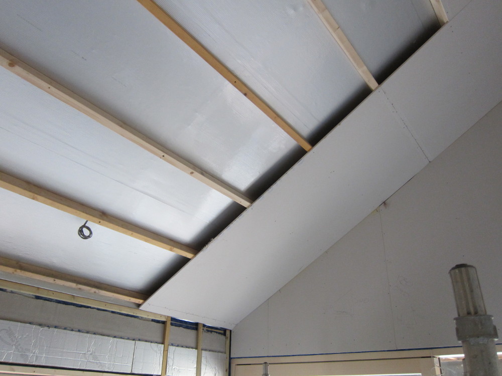Starting the dry-lining of the sloping ceiling over the Master Bedroom
