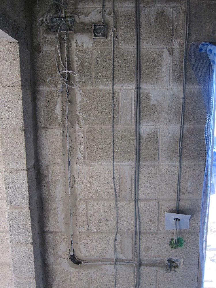 Conduit sealed into wall ready to take control cables for front door lock