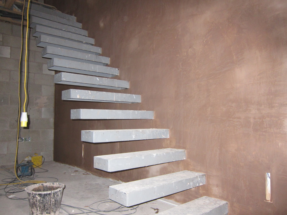 Plastered wall next to ground-to-first floor staircase