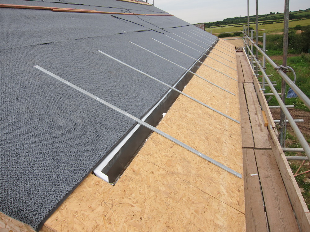 RHEINZINK VAPOZINC structured underlay and galvanized steel reinforcing straps on the south roof