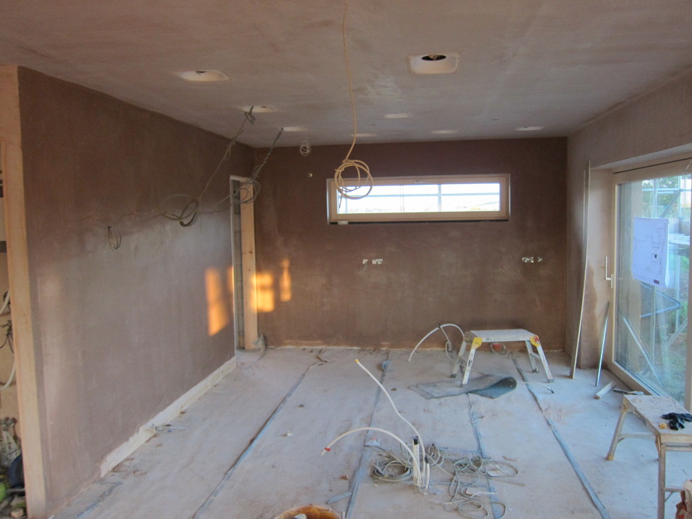 Finish ("skim") coat over the float-and-set wet plaster in the kitchen