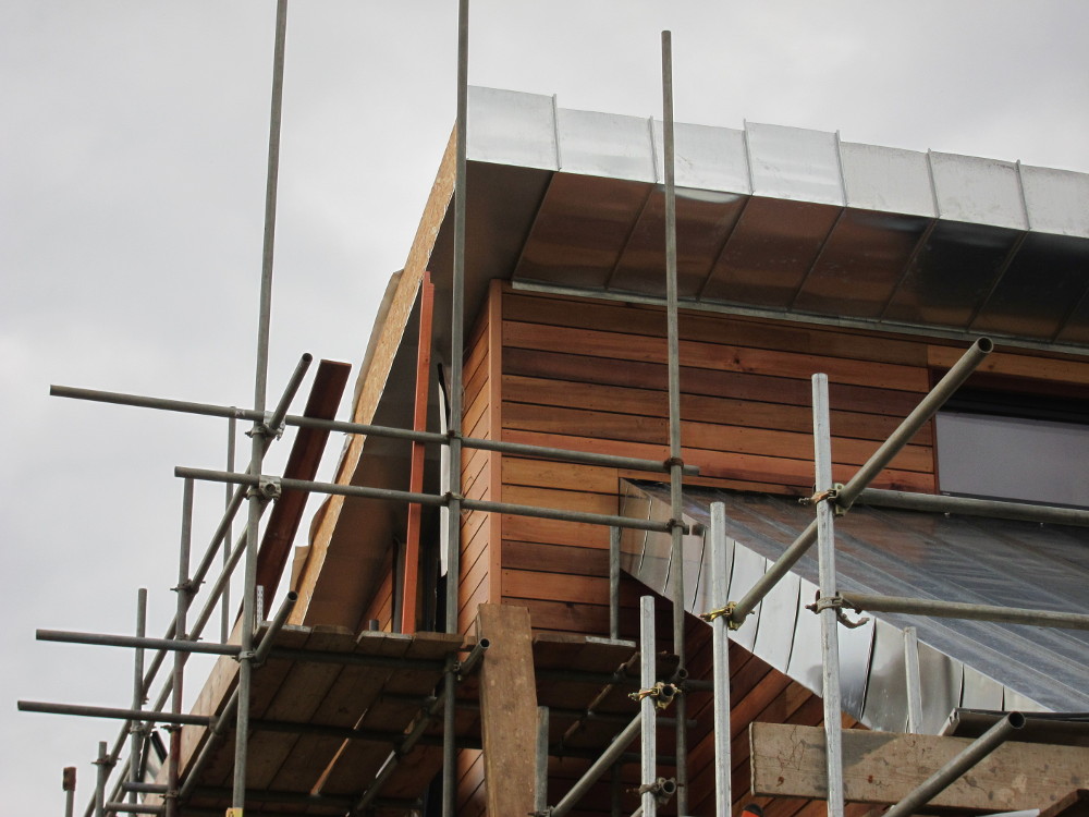 Finishing touches to the cedar cladding at the external corners