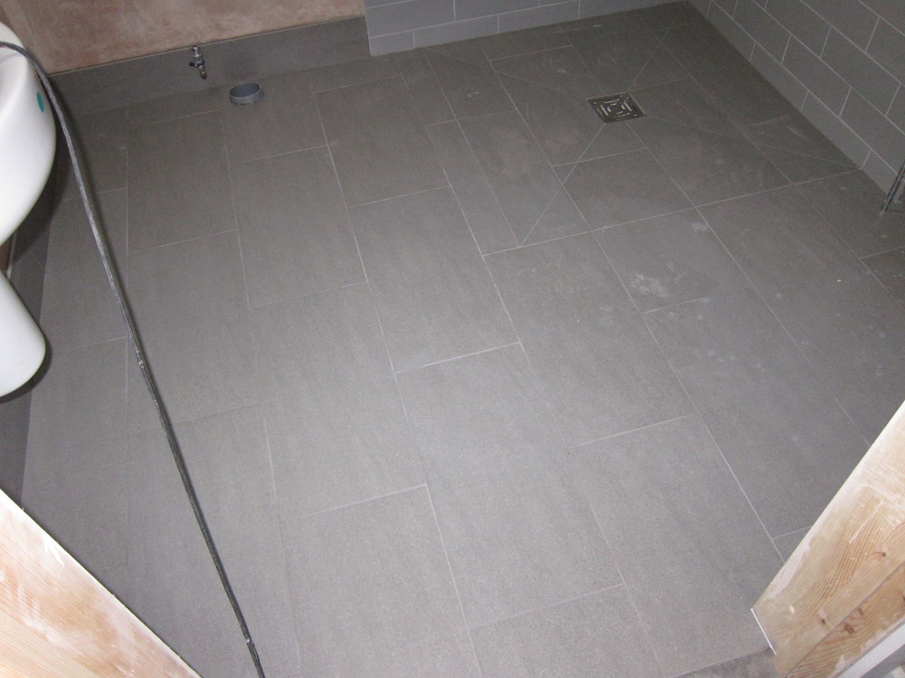 Grouted floor tiles in the ground floor Shower Room
