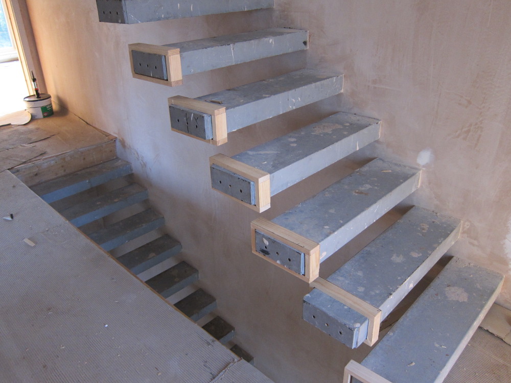 Temporary wooden boxes over staircase treads in preparation for templating for the glass