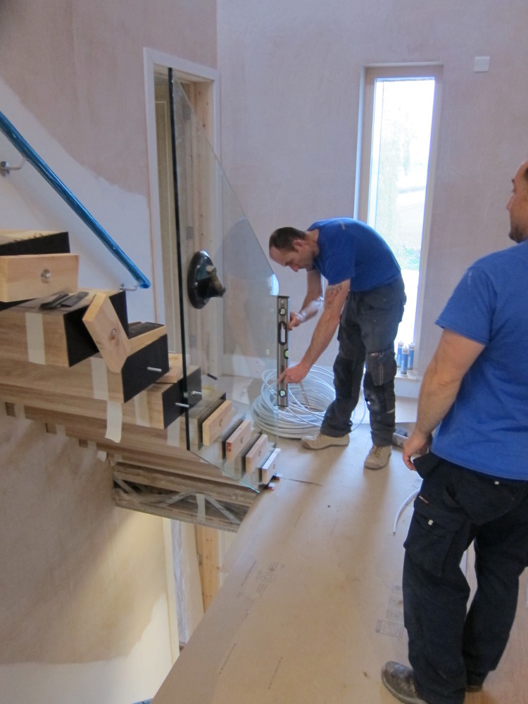 Alvaston Glass installing the first section of glass balustrade on the first-to-second floor staircase