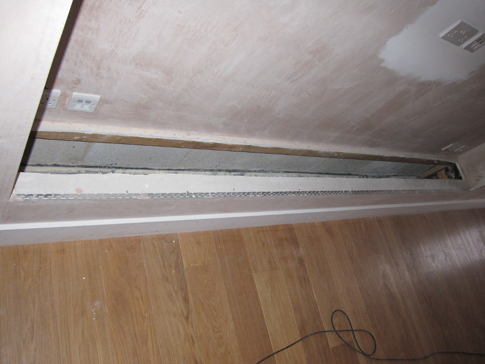 Creating an access to check for air leaks under the TV Alcove shelf in the Living Room